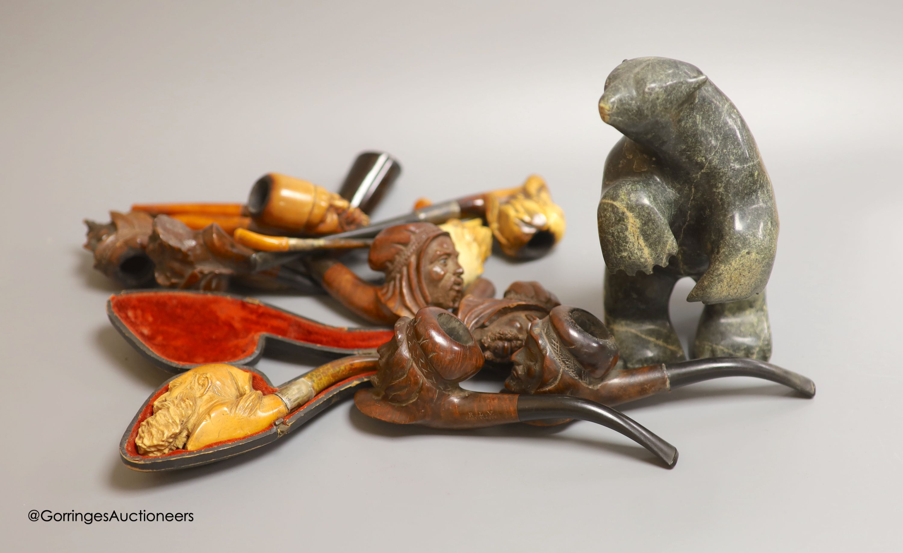 An Inuit stone bear and a collection of Meerschaum pipes